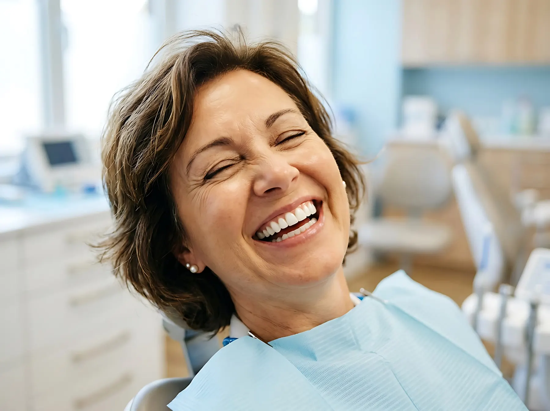 Patient laughing in the treatment chair at Smile By Design Dental Group in Irvine, California